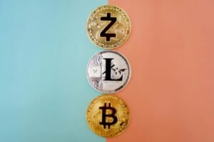 Colorful display of Zcash, Litecoin, and Bitcoin coins on gradient background.